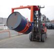 Heavy-duty forklift crane drum tilter moving a 210L drum outdoors, designed for safe lifting, tilting, and controlled pouring.