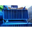Front-facing view of blue barriers, showing dense packing and welded vertical bars.