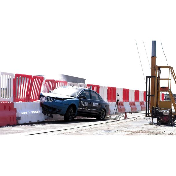 Full-speed impact captured during crash test of Defender50 barrier – barrier absorbs energy and redirects the vehicle.