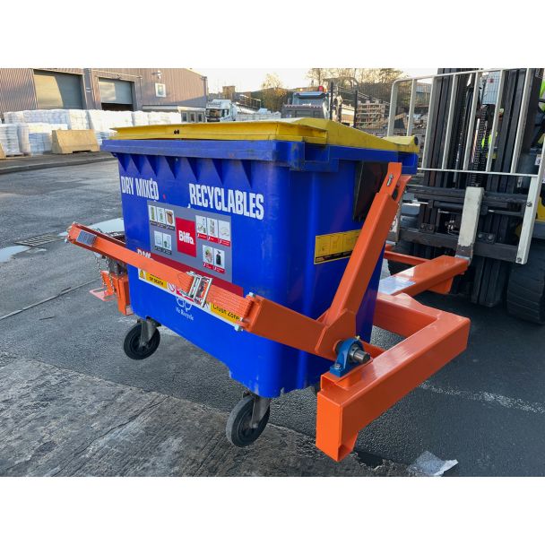 Forklift wheelie bin tipper attachment lifting blue recycling bin with yellow lid for efficient waste and recyclables handling.