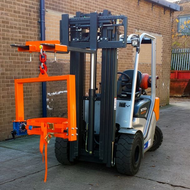 Heavy-duty forklift with adjustable hook and crane drum tilter attachment securing steel drum for safe lifting and controlled tipping.