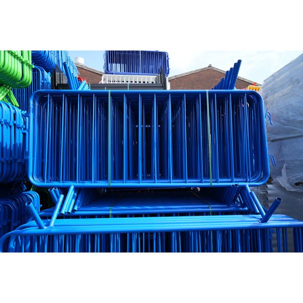 Front-facing view of blue barriers, showing dense packing and welded vertical bars.