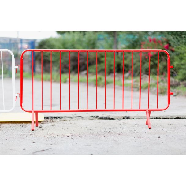 Real-world application of the barrier on concrete, positioned for pedestrian or site safety, with a white barrier partially visible beside it.